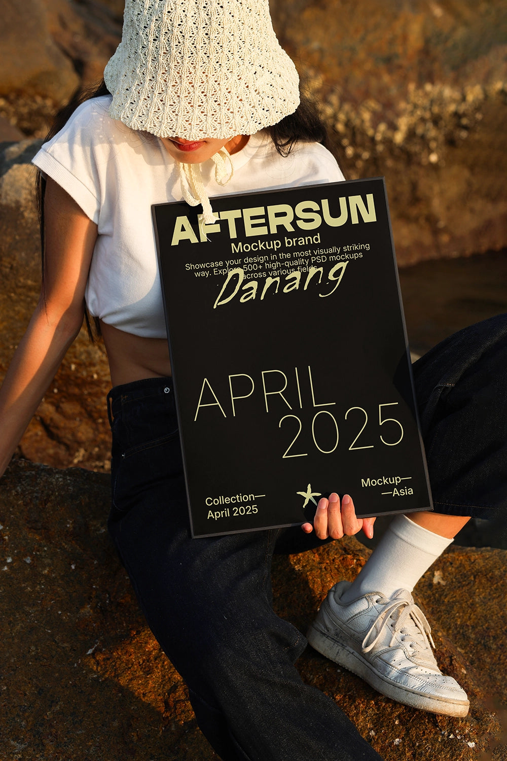 minimal poster mockup on model outdoor with natural light and textured rock background
