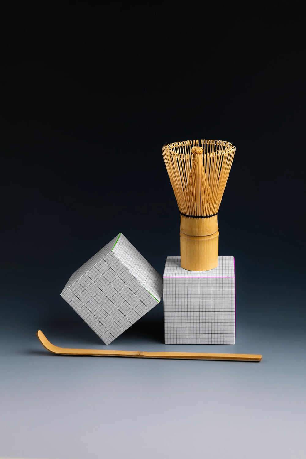 tea packaging box mockup with matcha whisk and spoon, modern studio product display