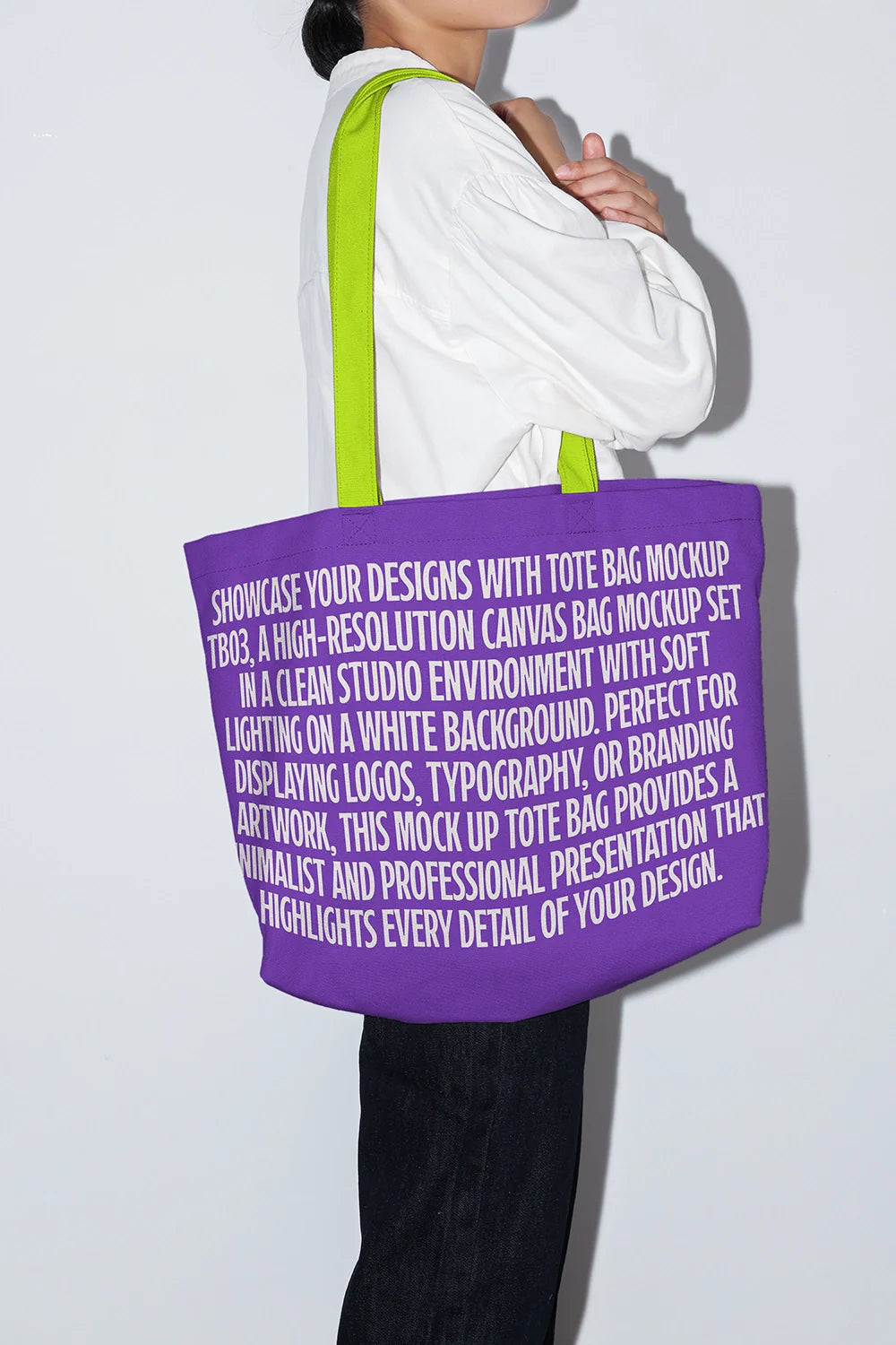cotton tote bag mockup with big text logo, side view on person in studio lighting