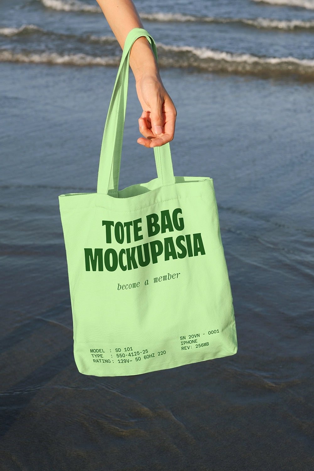 eco tote bag mockup in hand with seaside setting and soft natural lighting