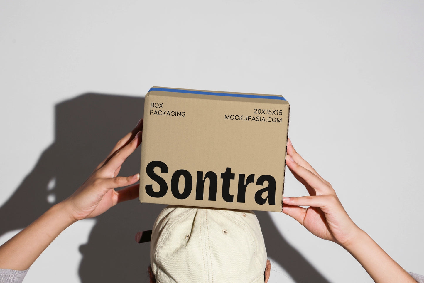 Kraft box packaging mockup with stacked boxes and realistic handheld presentation