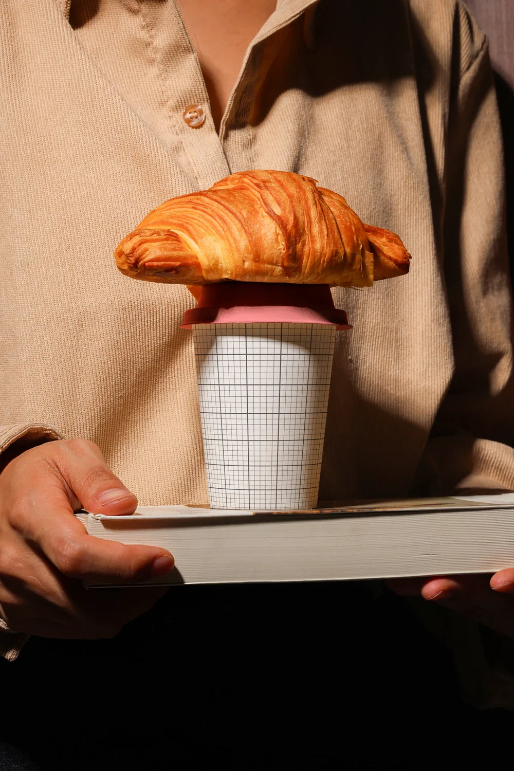 takeaway coffee cup mockup with croissant and hands holding tray, premium presentation