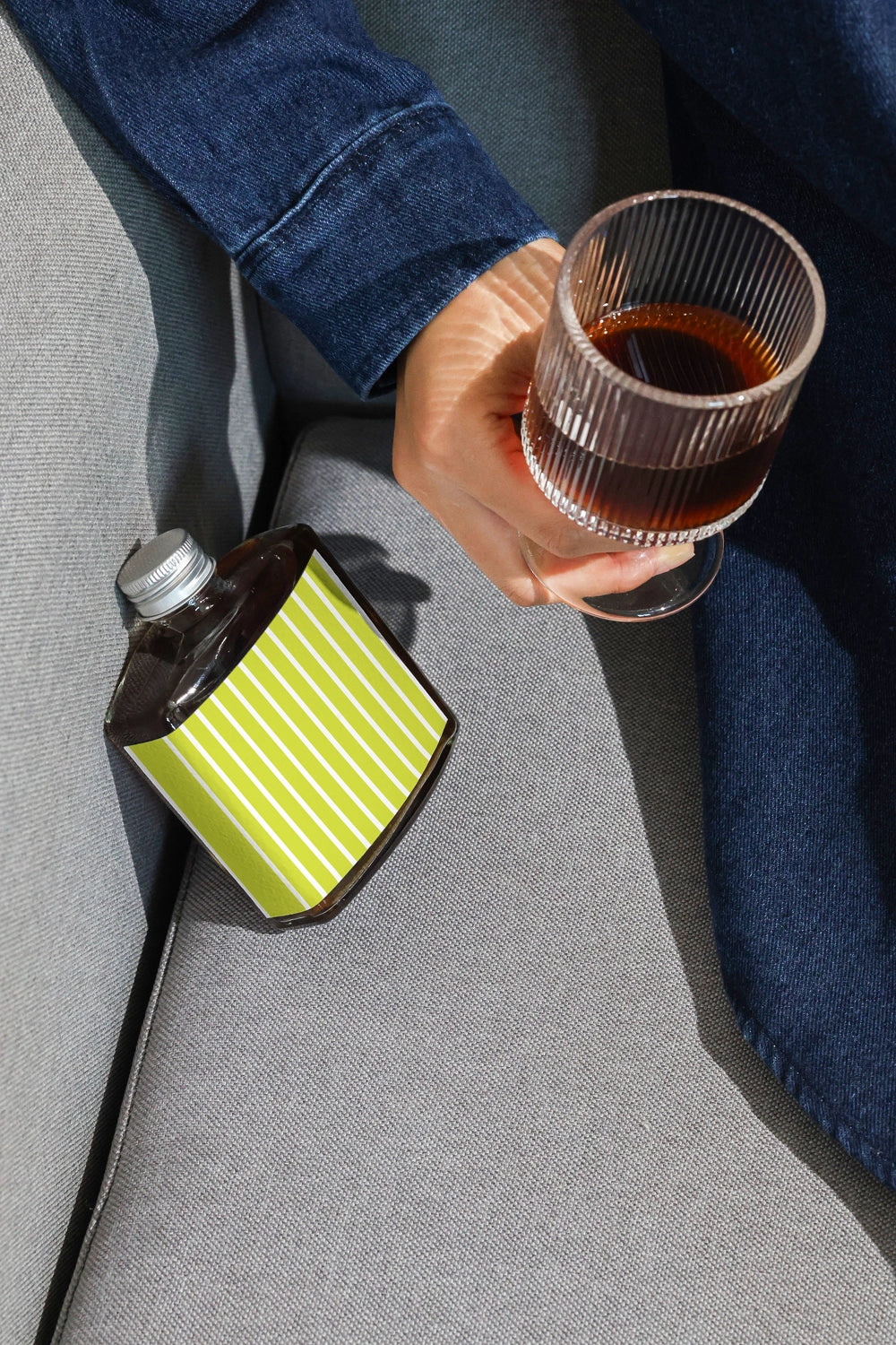 Coffee packaging mockup with hand holding drink and bottle nearby