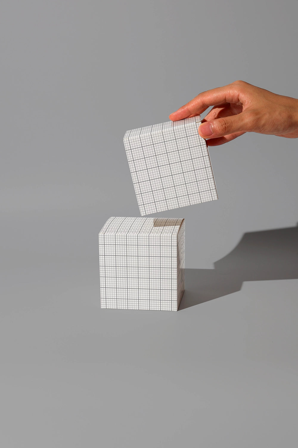Packaging mockup with small cube boxes and realistic shadow lighting dark studio scene