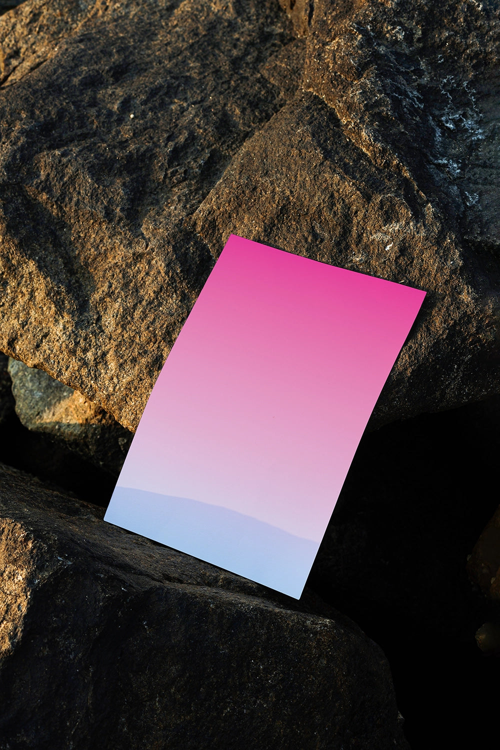 realistic poster mockup placed on stone background with warm natural lighting
