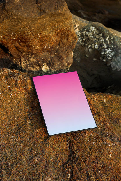 realistic poster mockup placed on stone background with golden hour lighting and natural texture