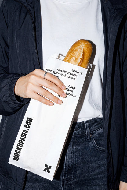 bakery paper bag mockup with baguette in hand high contrast flash lighting