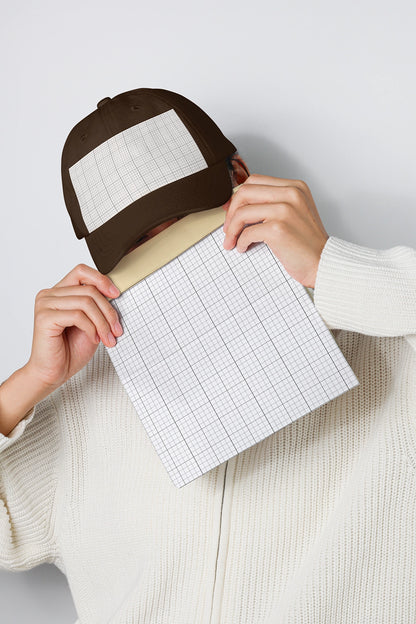 baseball cap mockup with grid panel held in hands and minimal neutral background