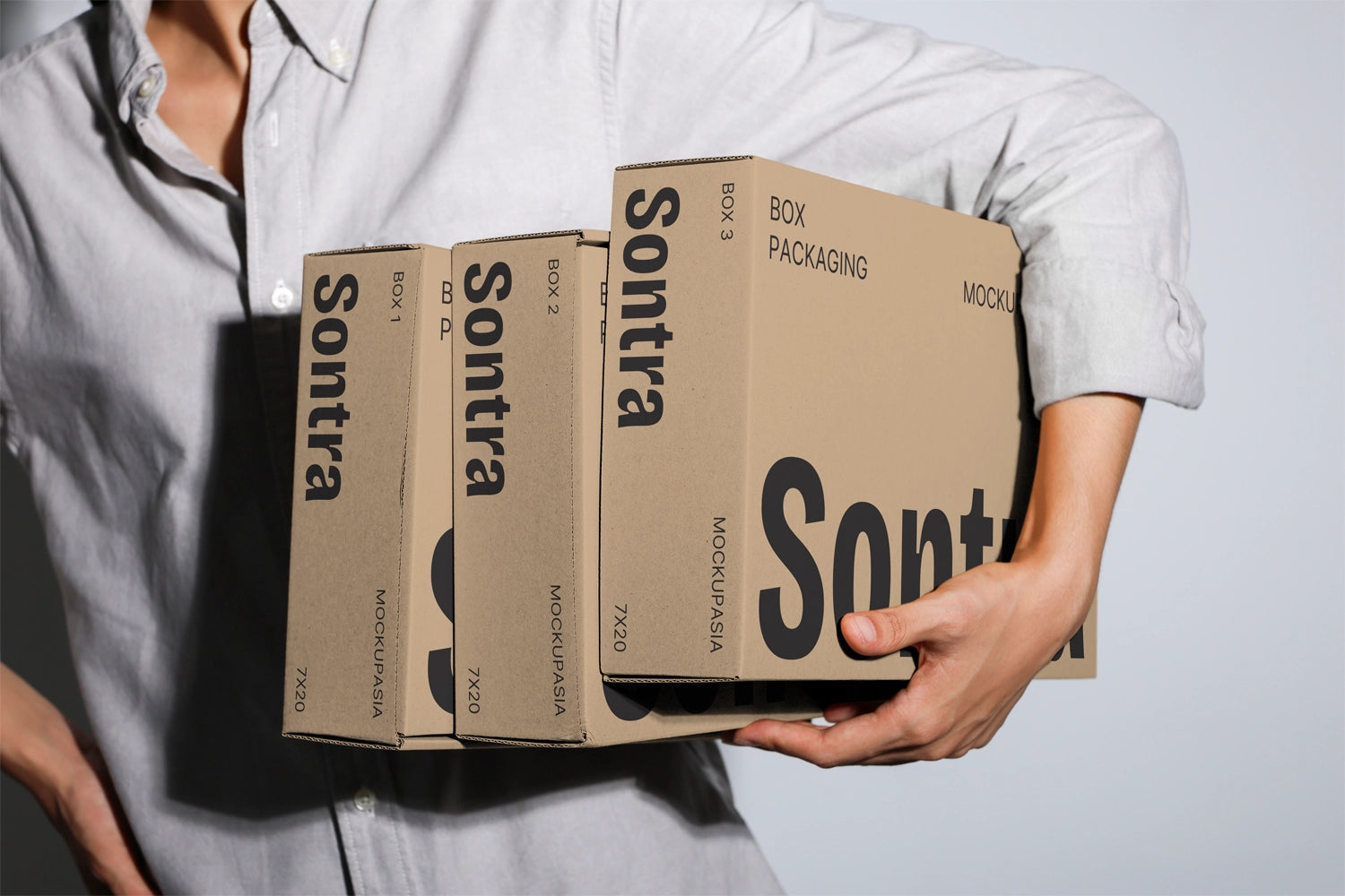 Cardboard box mockup set held in hands with multiple packaging boxes minimal background