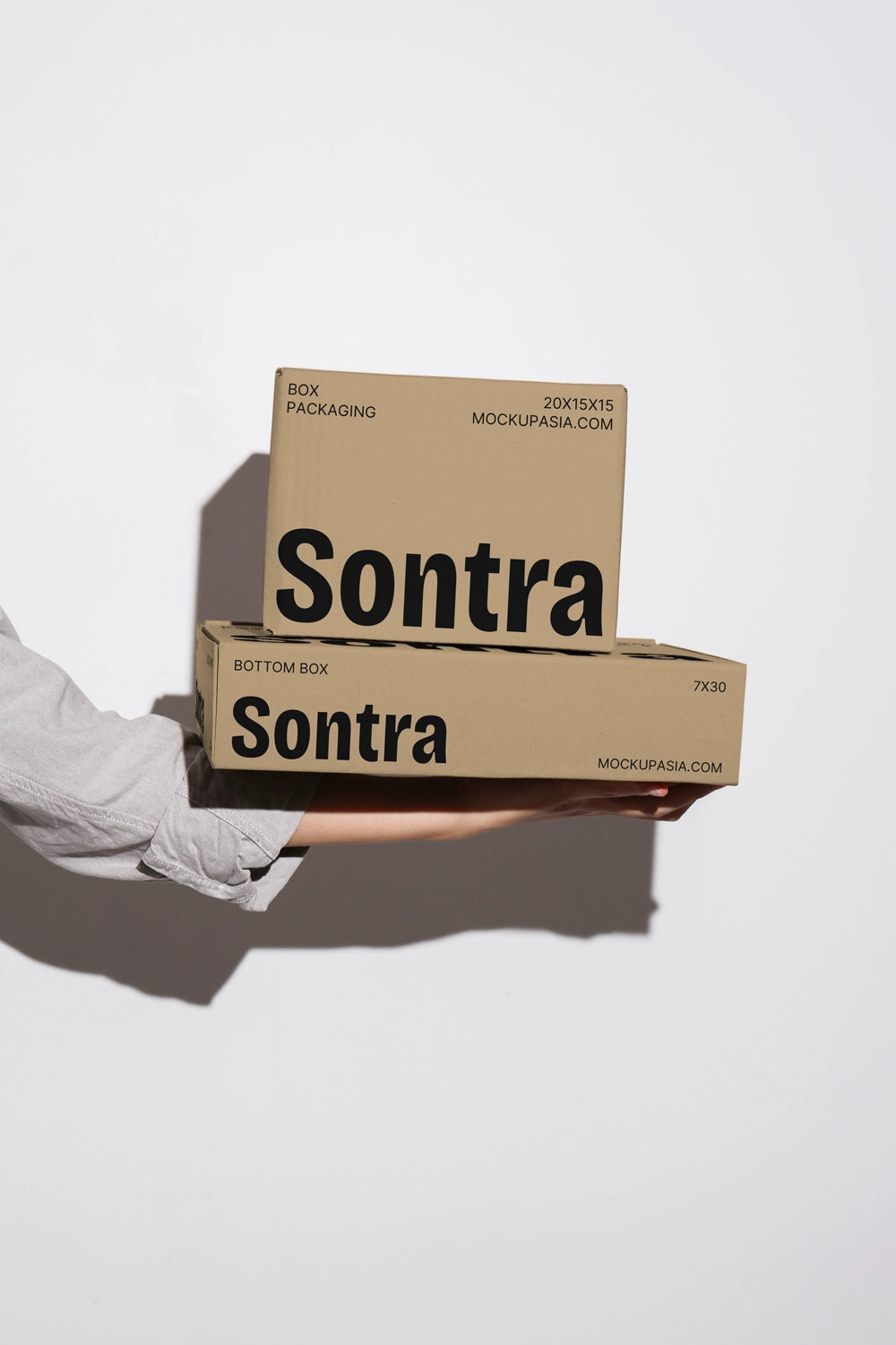 Kraft box packaging mockup with stacked boxes and realistic handheld presentation
