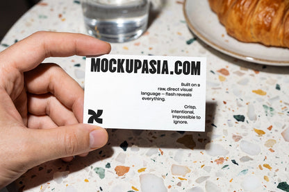 business card mockup in hand coffee branding with high contrast flash lighting