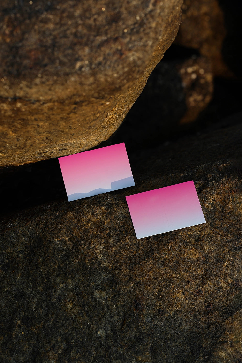 realistic poster mockup placed on stone background with golden hour lighting and natural texture