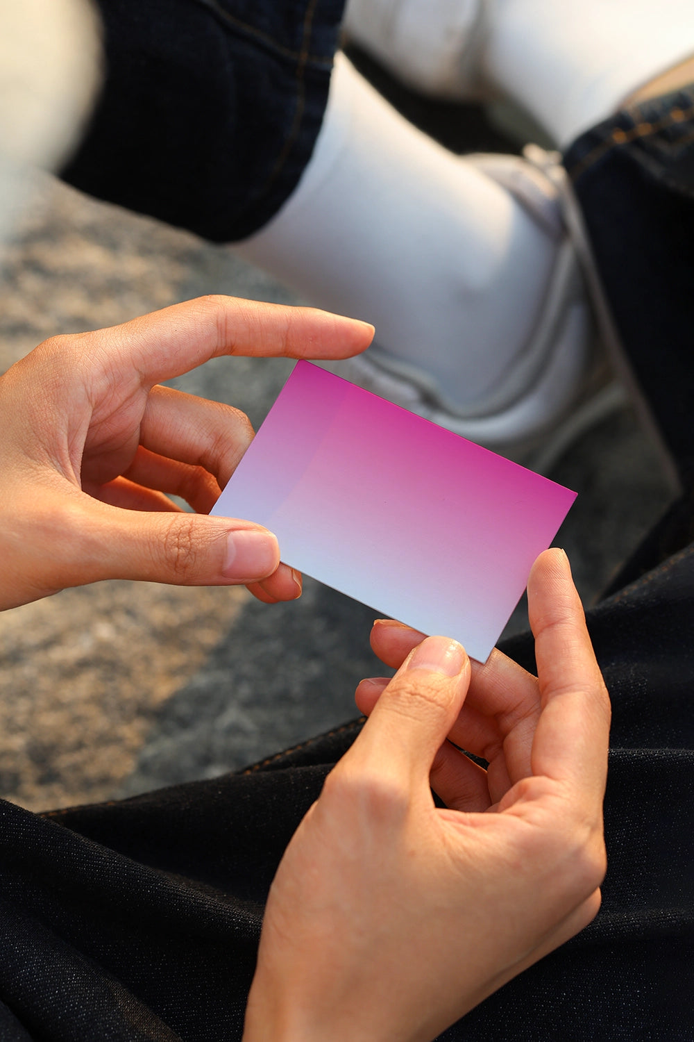 minimal business card mockup close up in hands with warm lighting and lifestyle setting