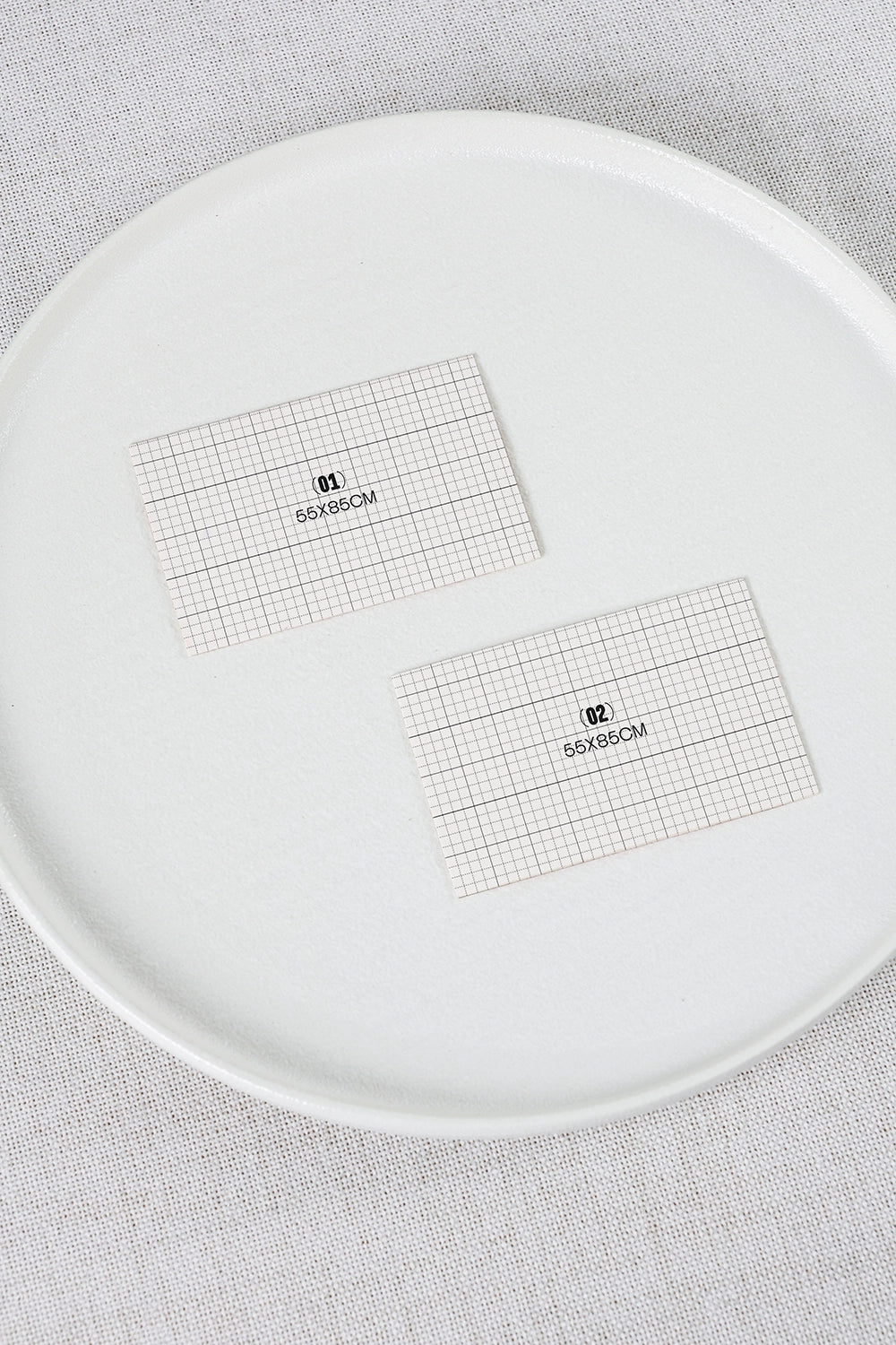 stationery mockup with two business cards on plate and soft natural lighting