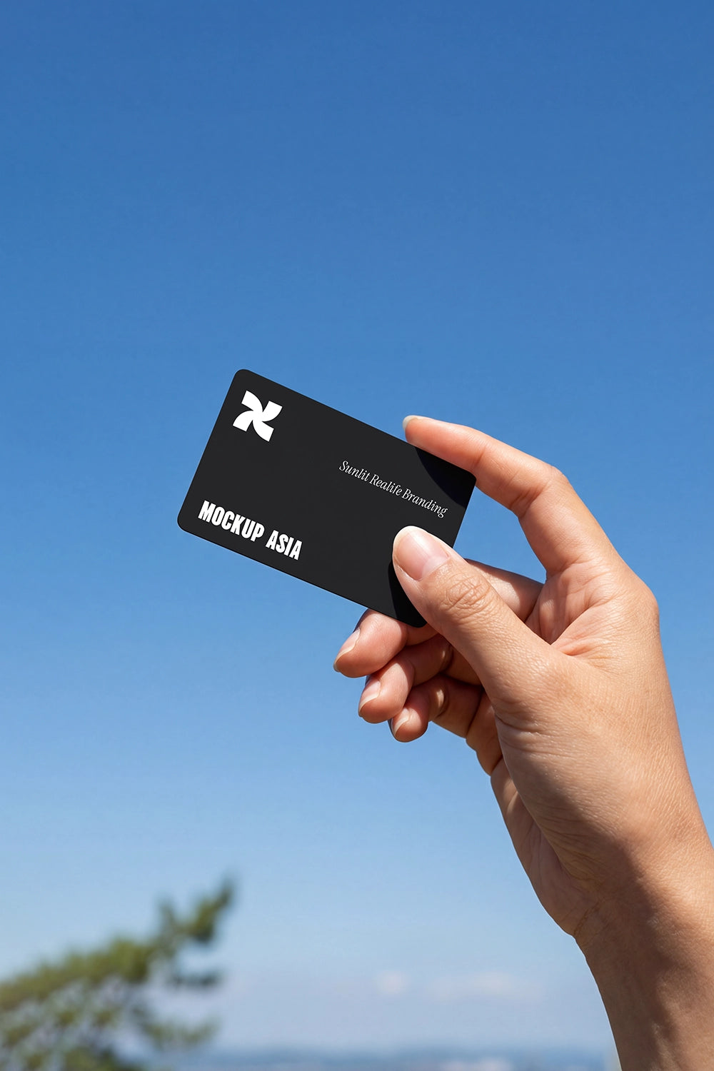 realistic plastic rounded card mockup in hand for membership id or gift card outdoor sky background