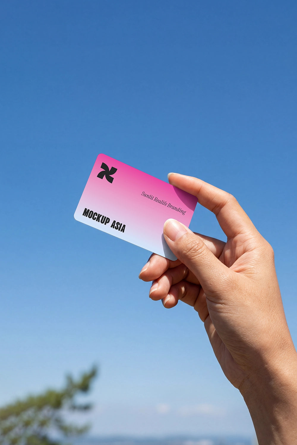 minimal rounded edge card mockup held by fingers with clean sky and soft natural lighting