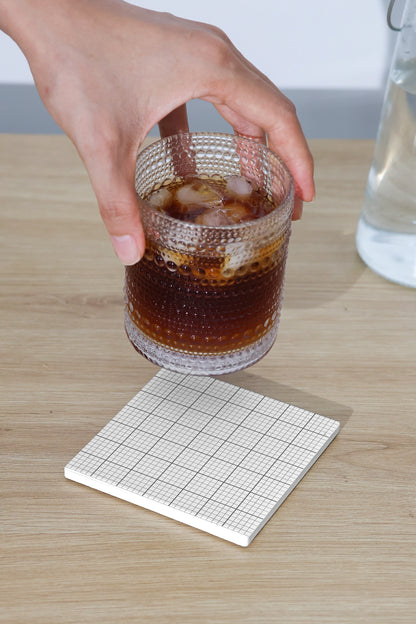 coaster branding mockup with glass cup and natural lighting