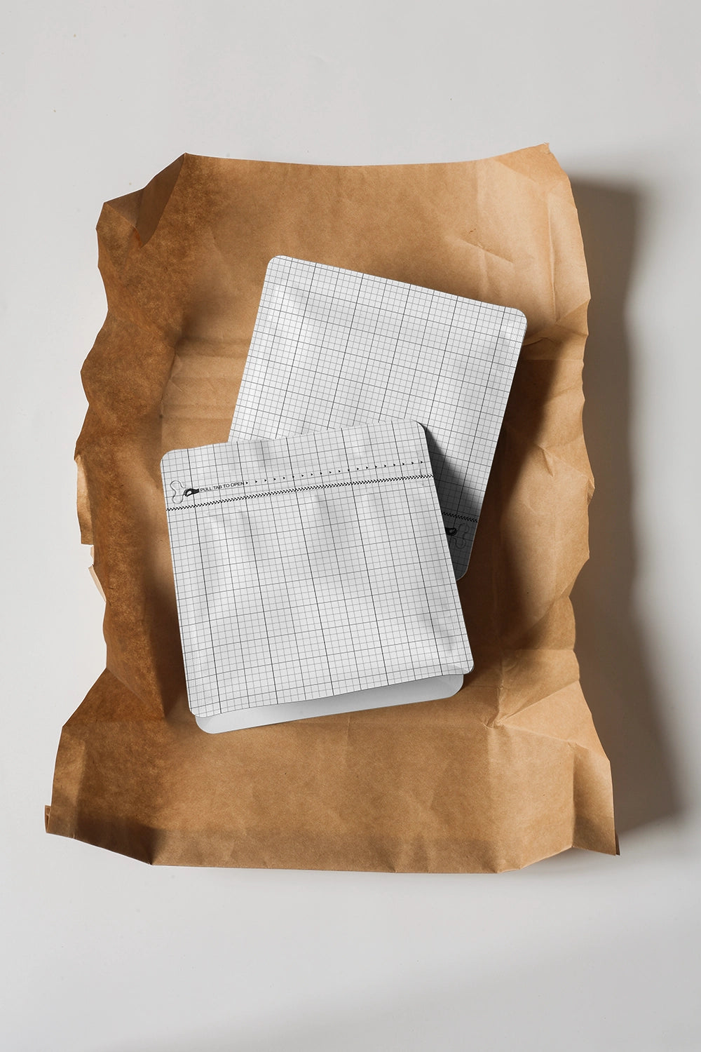 stand up coffee pouch mockup on crumpled paper, natural and organic branding scene