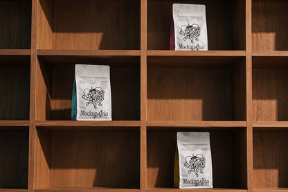 Flat bottom coffee bag mockup PSD three pouches on wooden shelf