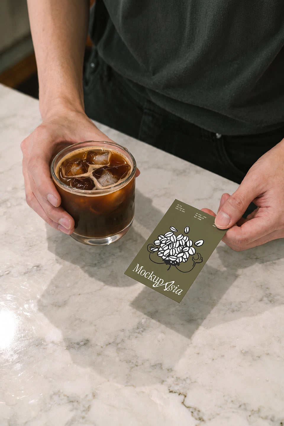 Barista serving iced coffee with brand card mockup