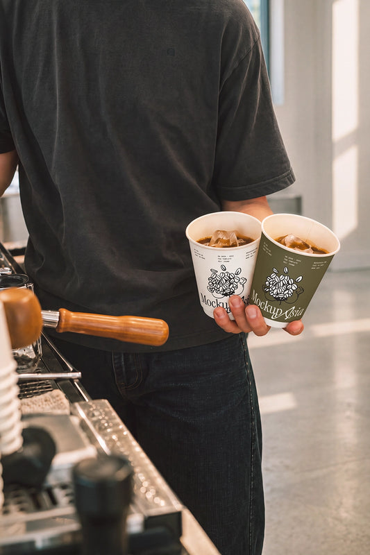 Iced coffee cup mockup PSD barista holding two paper cups