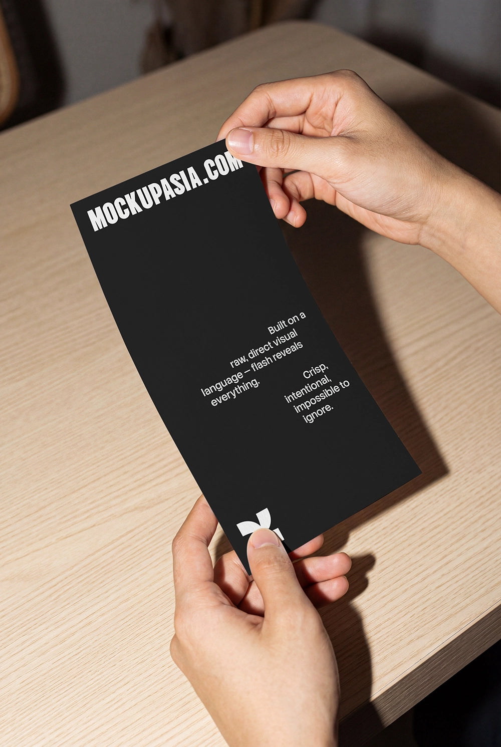 vertical menu card mockup held by hands with direct flash shadows on wooden table