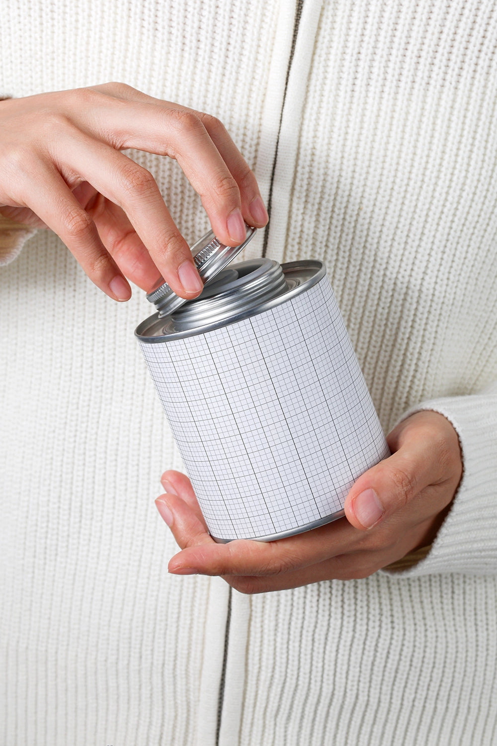 coffee tin packaging mockup held in hands with opening action, realistic product display