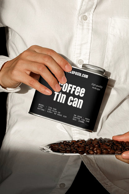coffee packaging tin mockup with beans and hand interaction, lifestyle product scene