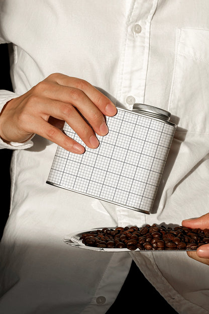 coffee tin packaging mockup with pouring beans action, minimal and realistic presentation