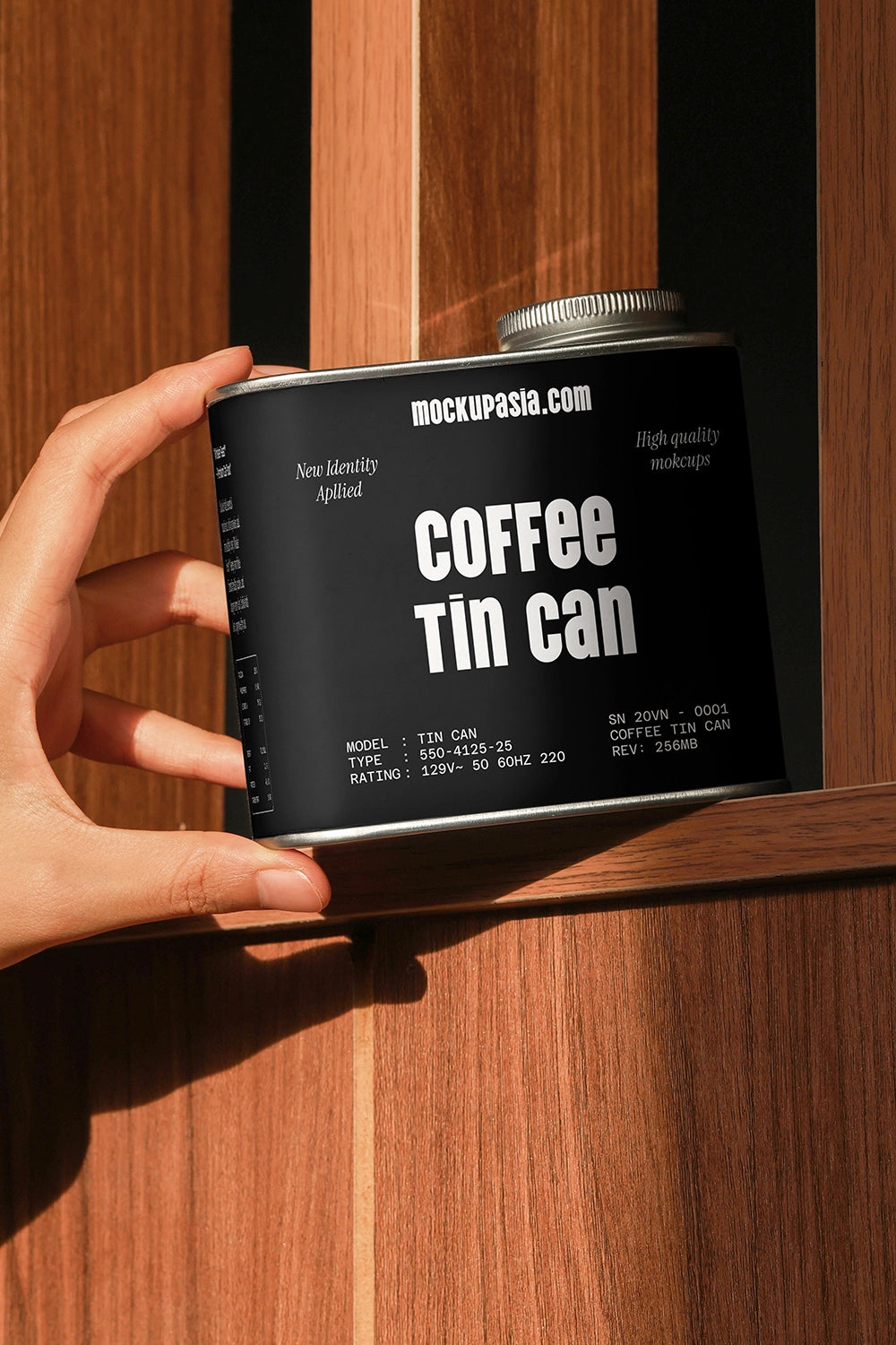 coffee packaging tin mockup with hand holding container on wood background, lifestyle scene