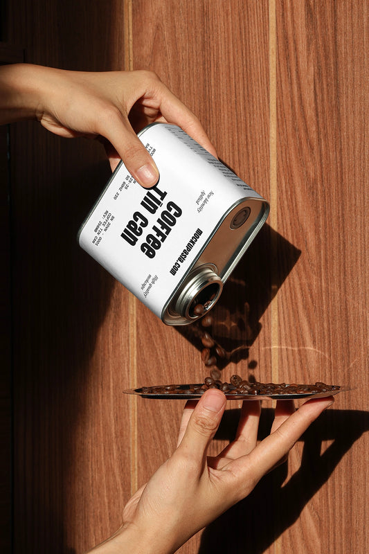 coffee tin can mockup pouring coffee beans with hands, natural sunlight and wooden background