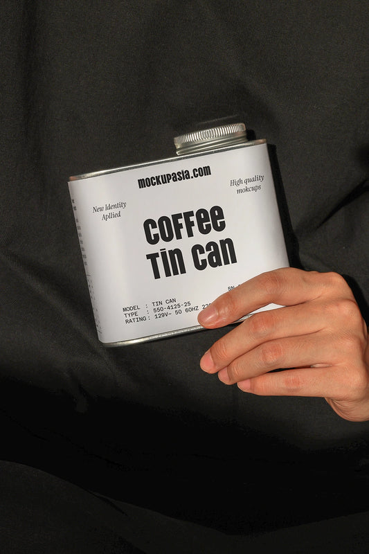 coffee tin can mockup held in hand with dark fabric background, minimal product presentation