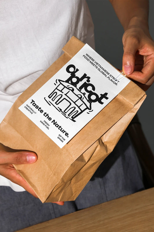 Handheld kraft coffee bag mockup with white label and minimal branding in natural light