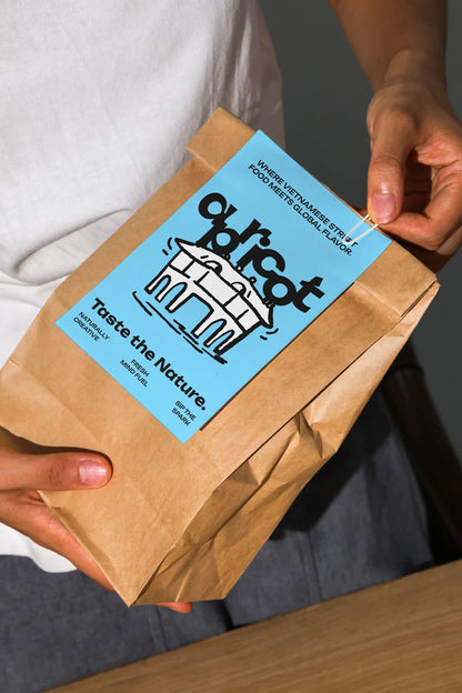 Lifestyle coffee bag mockup showing brown paper packaging held in hands