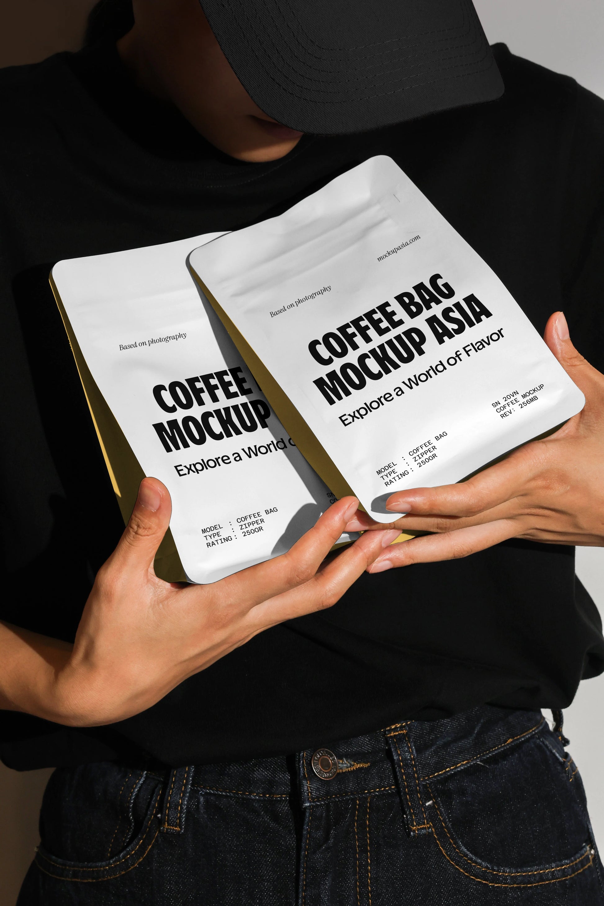 Handheld coffee bag mockup with two white pouches against dark background and dramatic lighting