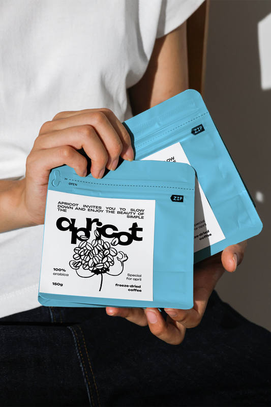 Handheld coffee bag mockup with blue zip pouch and minimalist label design in natural light