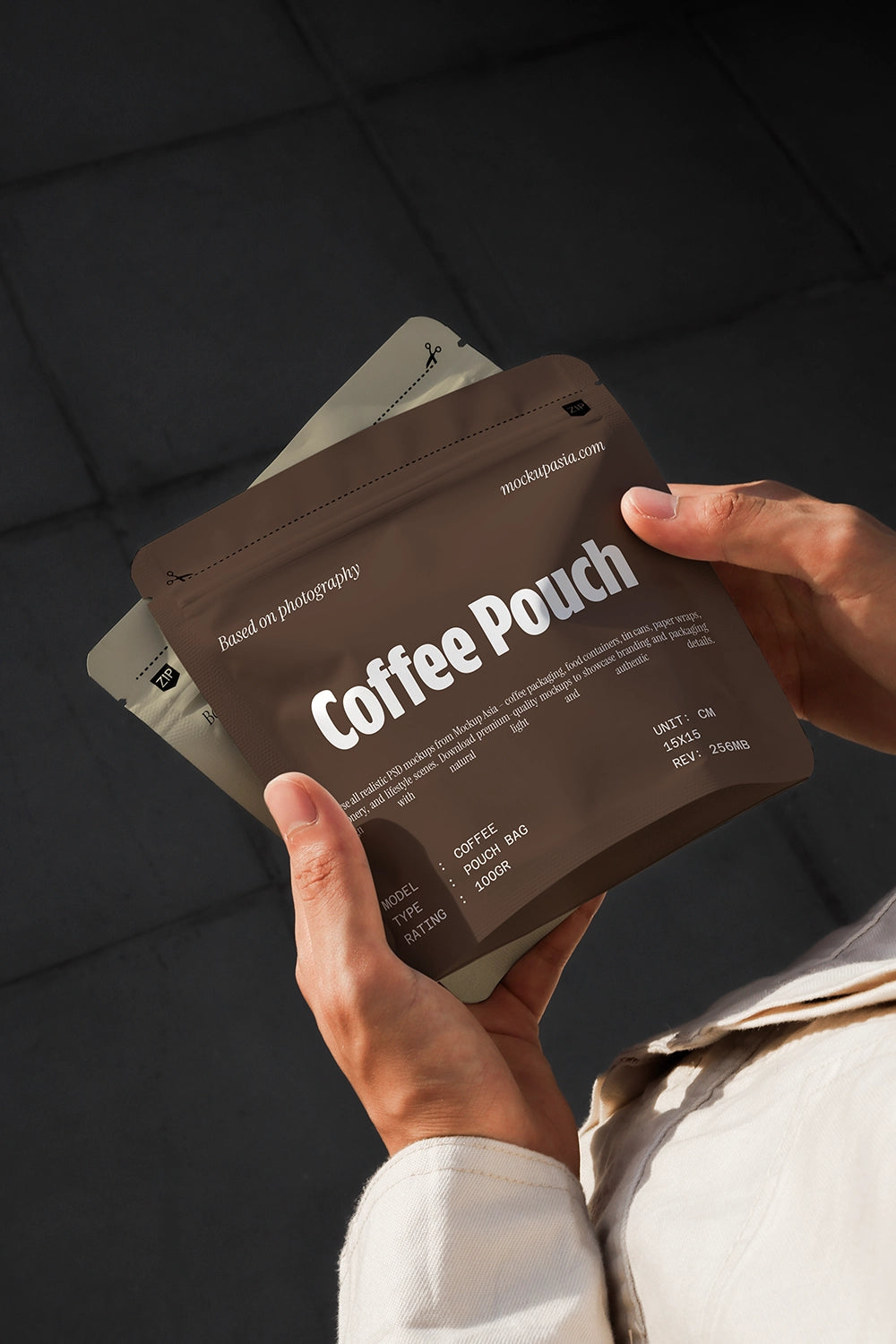 Lifestyle coffee pouch mockup showing multiple white pouches held in hands on dark background