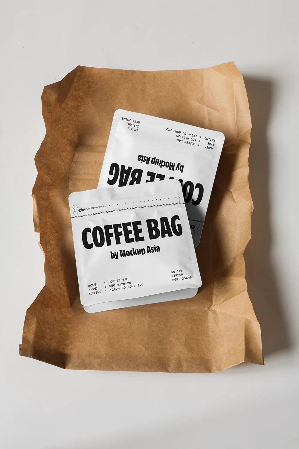 Flat lay coffee bag mockup with white pouch placed on crumpled kraft paper background
