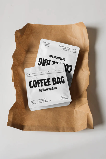 Flat lay coffee bag mockup with white pouch placed on crumpled kraft paper background