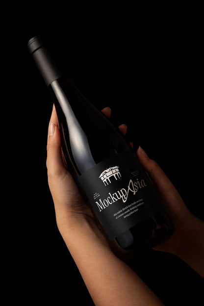 Editable packaging label mockup on dark glass bottle with clean background