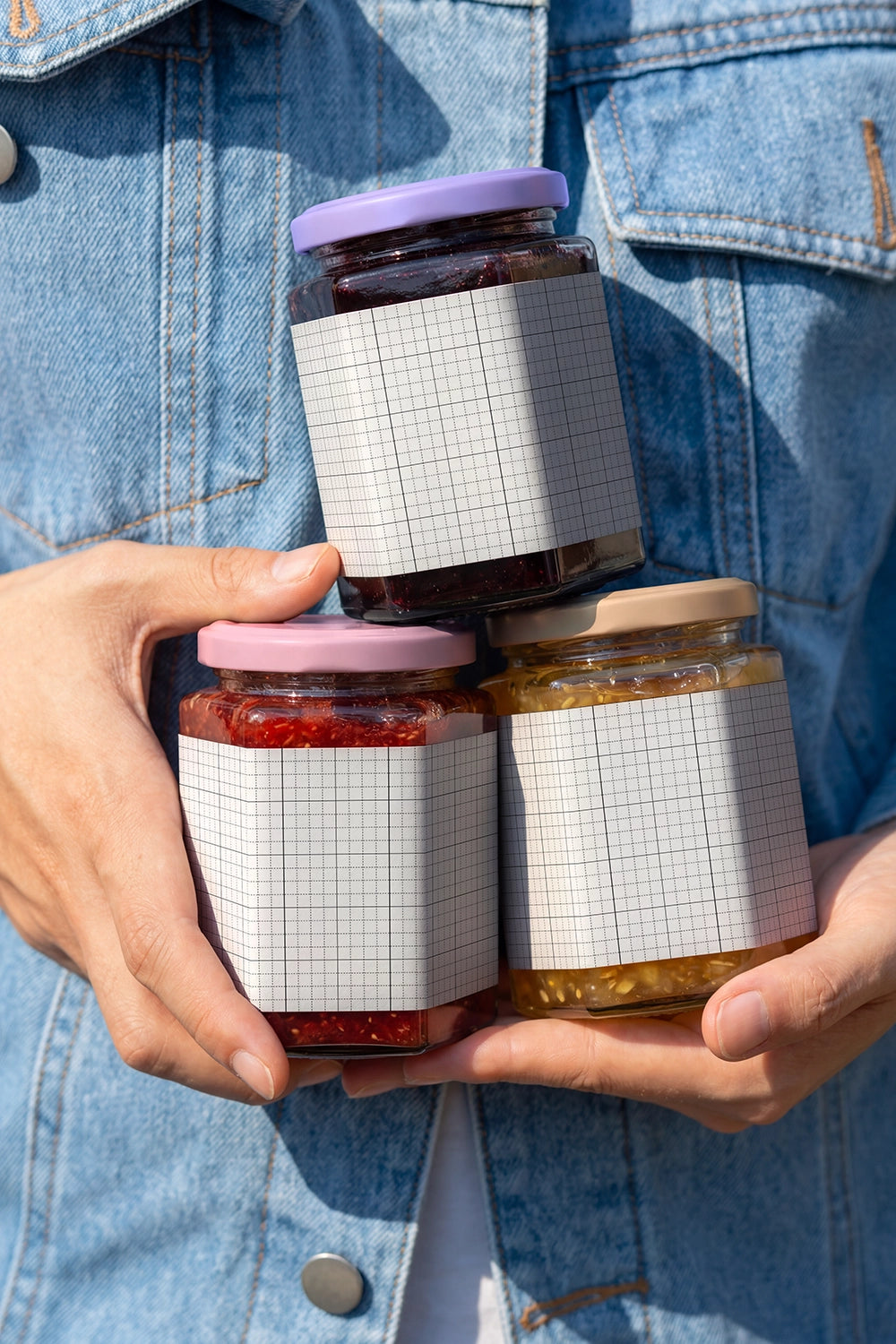 Premium food packaging mockup featuring three glass jars in lifestyle scene