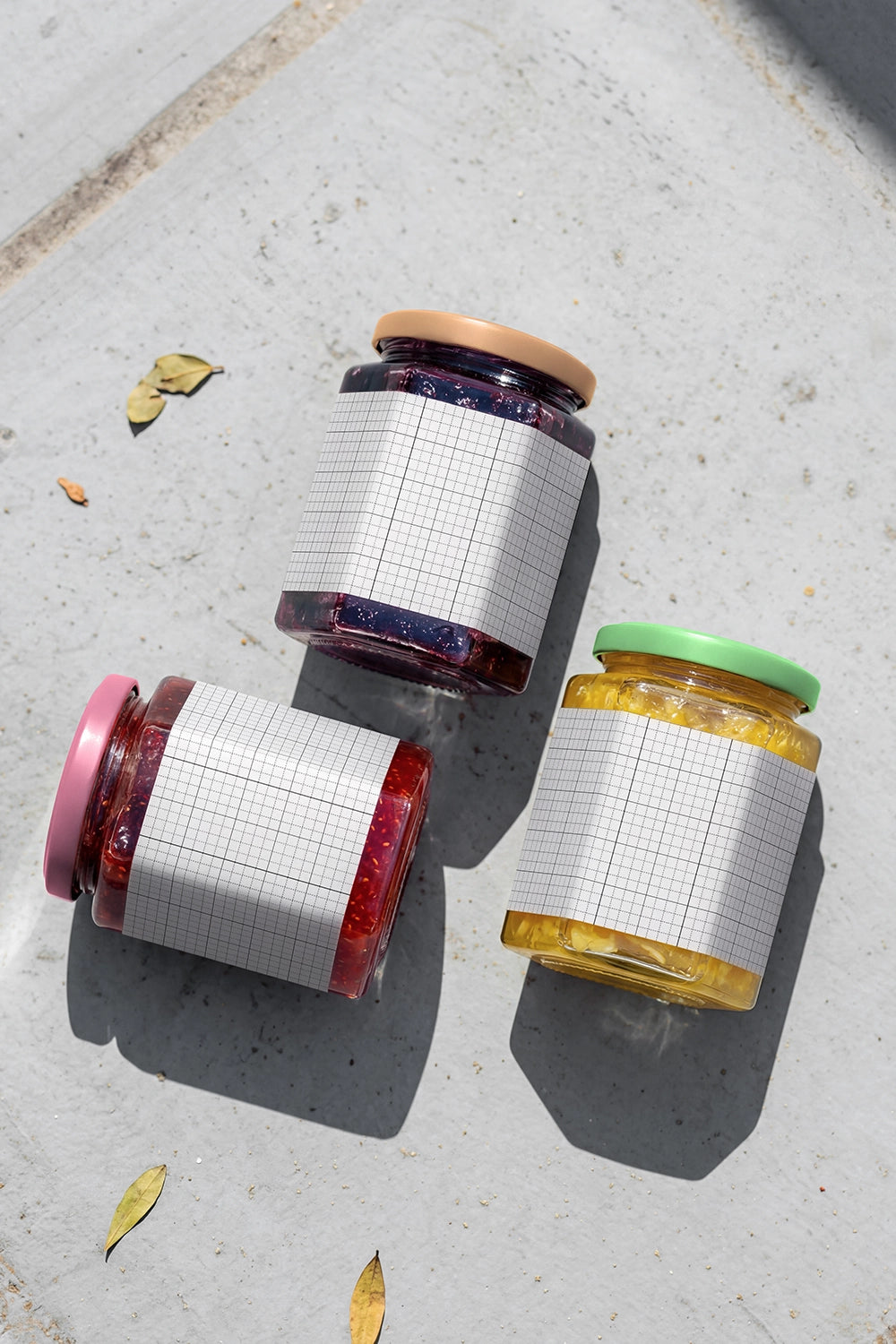 Jam and honey jar packaging mockup arranged on concrete surface