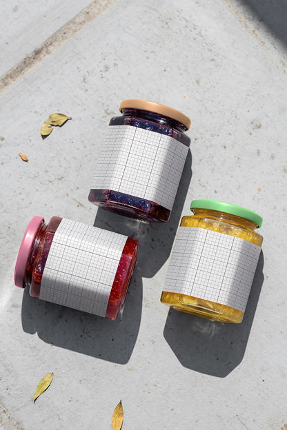 Jam and honey jar packaging mockup arranged on concrete surface