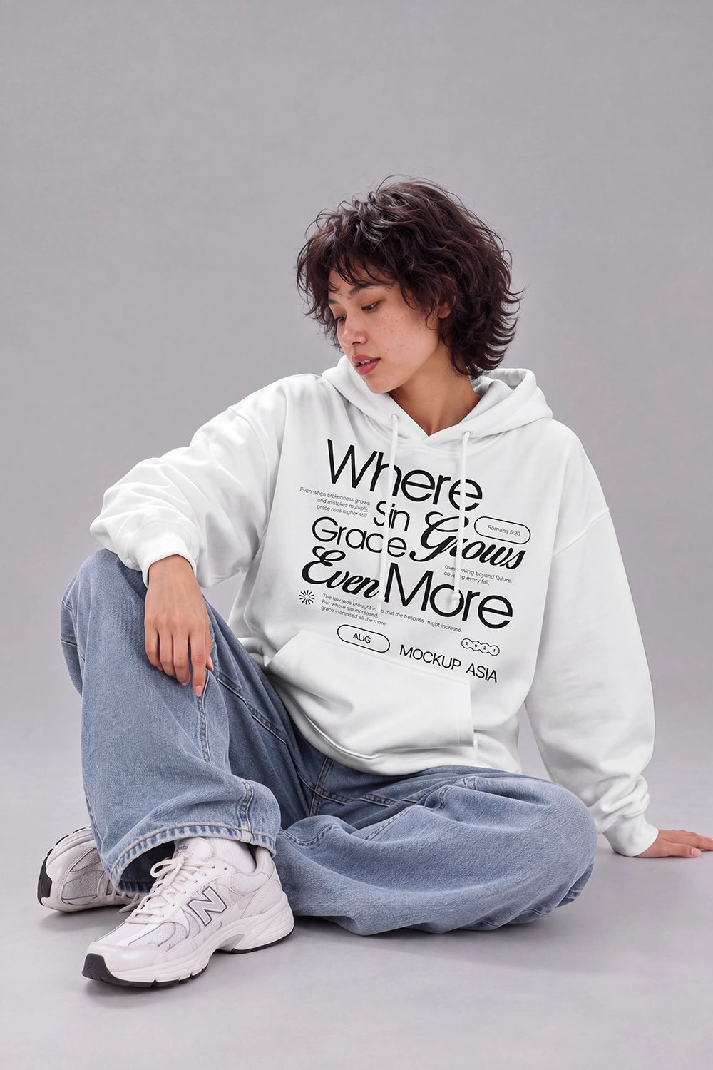 White hoodie mockup with female model sitting on studio floor