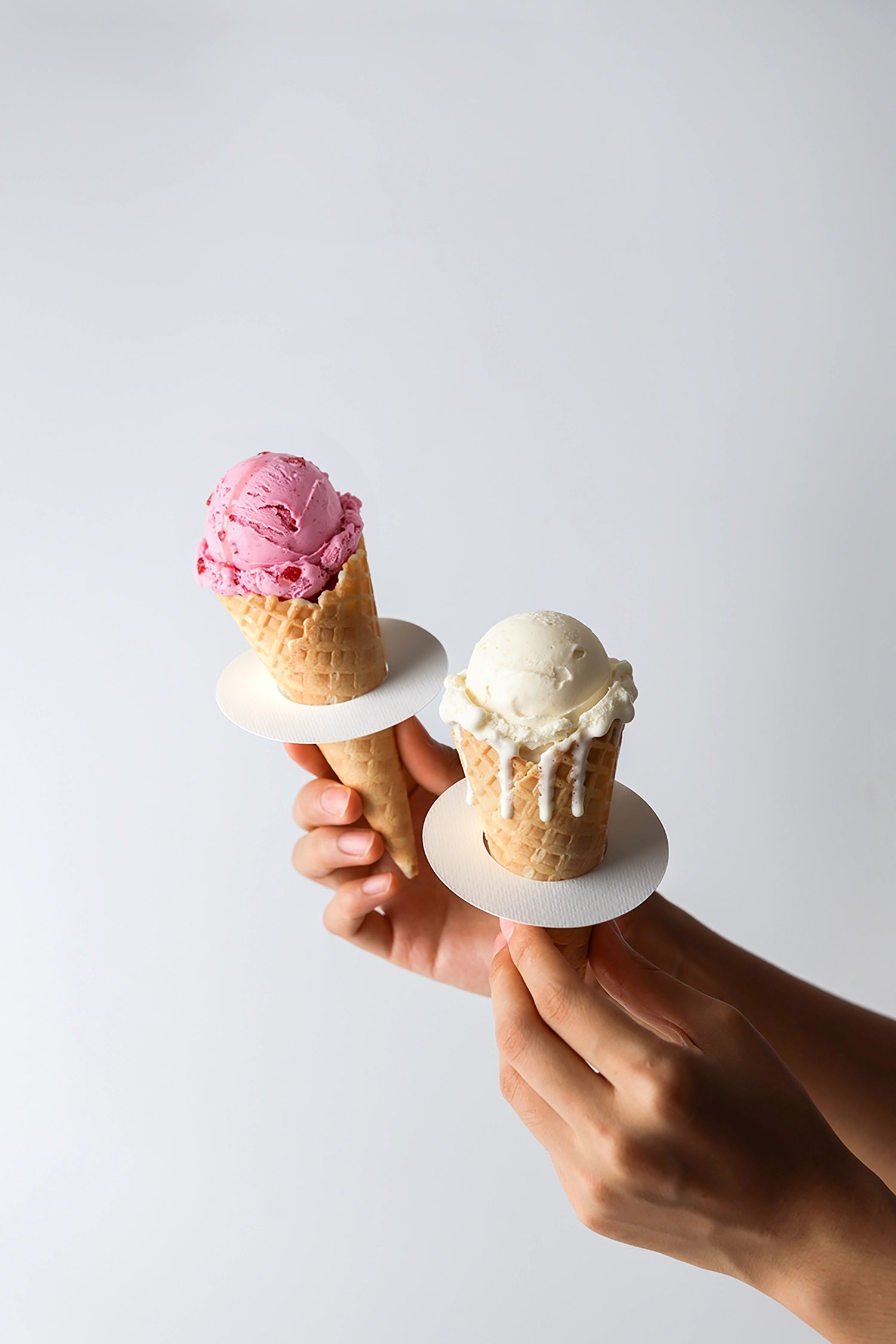 Ice cream branding mockup with handheld cones and realistic scoop texture detail