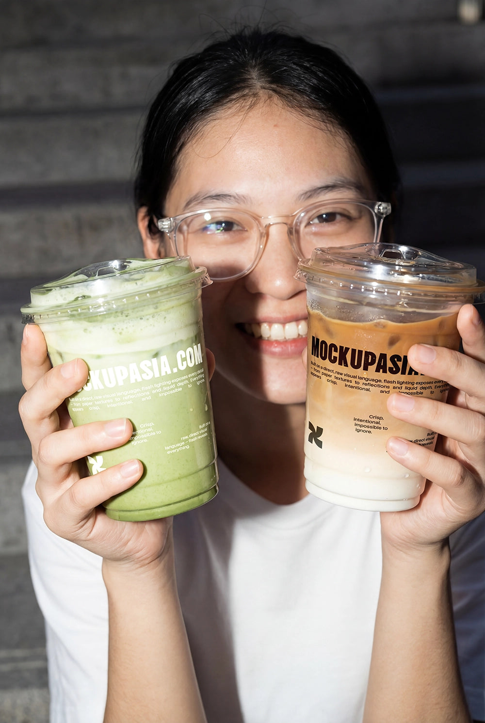 dual drink mockup with iced coffee and matcha cups held in hand under flash