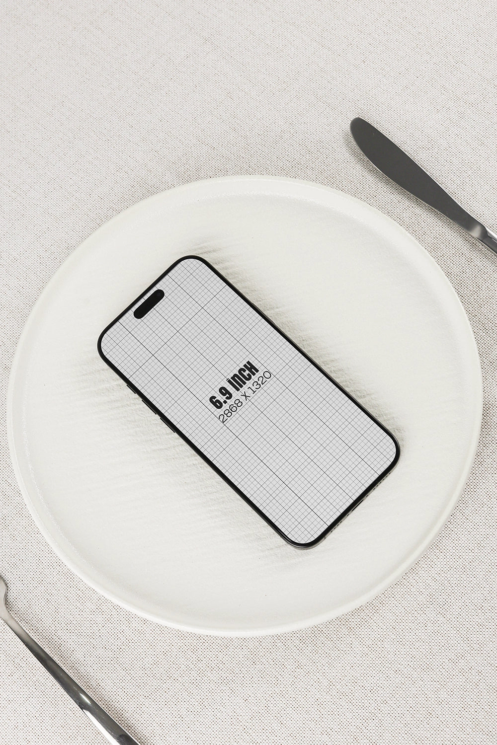 smartphone mockup on plate with minimal table setting and top view composition