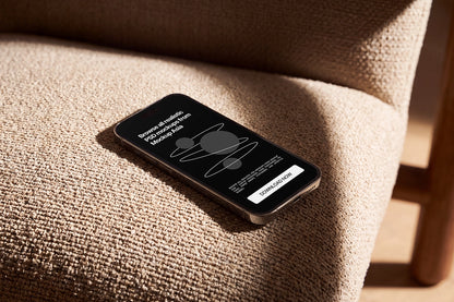 Smartphone mockup for app and website presentation on fabric sofa