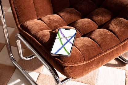 Premium phone mockup resting on a modern brown upholstered chair
