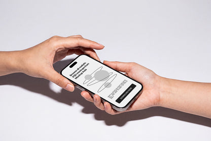 Two hands holding a smartphone against a clean white background. The phone screen displays a minimalist app interface with a gray ring graphic and text, and the phone itself has a black front and silver edges.
